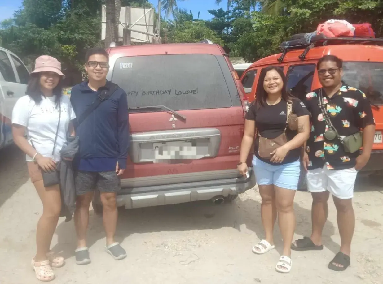 Four clients enjoying a car rental with driver service in Cebu City.