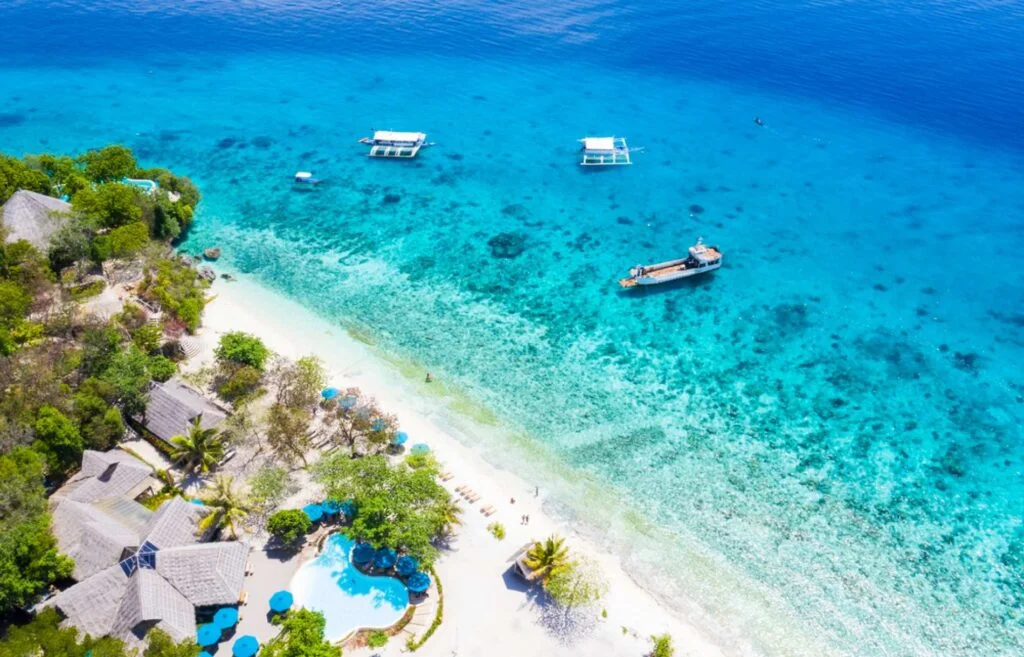 Aerial view of Bluewater Sumilon Island Resort showcasing its pristine white sand beaches and turquoise waters.